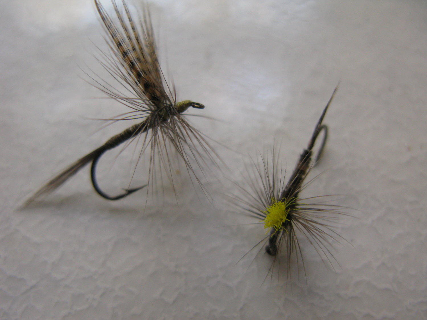 The parachute pheasant tail nymph, right, drifts in the surface film, unlike a traditional dry fly that floats on the surface.
